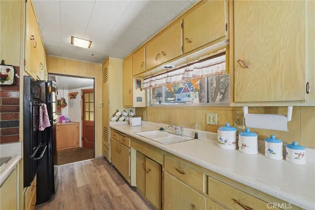 a kitchen with refrigerator cabinets and wooden floor