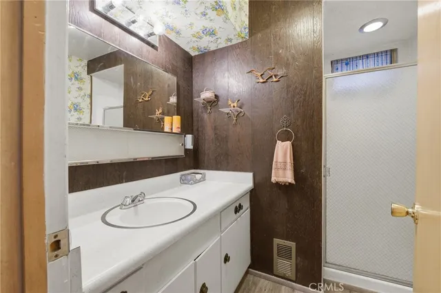 a bathroom with a sink a mirror and vanity