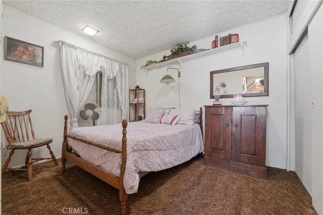 a spacious bedroom with a bed and a table in it