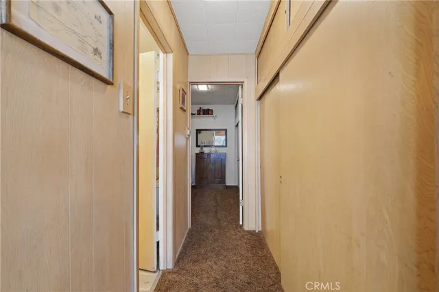 a view of a hallway with wooden shelves