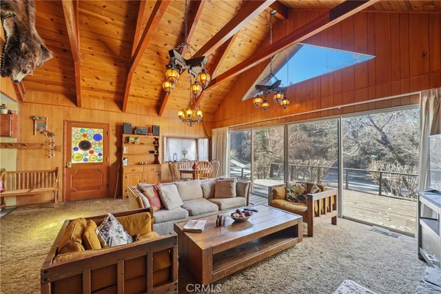 a living room with furniture a fireplace and large windows