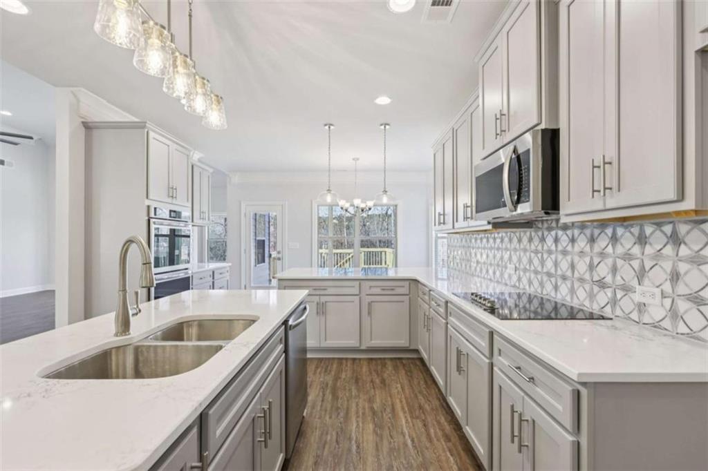 1833 Millstone Manor Conyers, GA 30013 - Photo 13 of 50 a kitchen with a sink stove and microwave