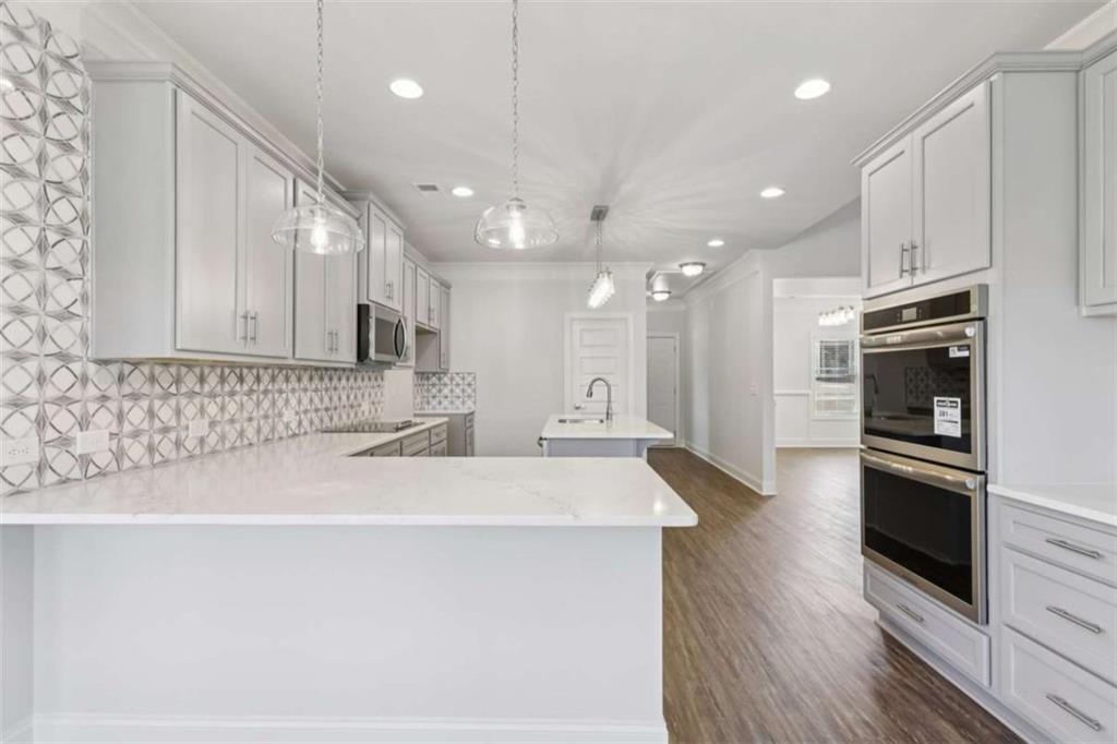1833 Millstone Manor Conyers, GA 30013 - Photo 14 of 50 a kitchen with stainless steel appliances a refrigerator sink and stove