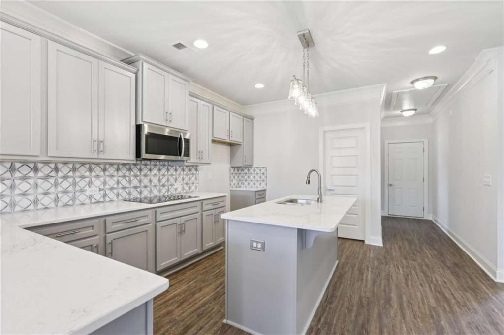 1833 Millstone Manor Conyers, GA 30013 - Photo 15 of 50 a kitchen with a sink stove and cabinets