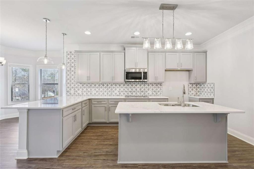 1833 Millstone Manor Conyers, GA 30013 - Photo 17 of 50 a large kitchen with granite countertop a sink a counter space appliances and cabinets
