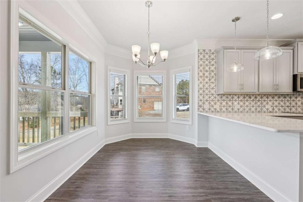 1833 Millstone Manor Conyers, GA 30013 - Photo 18 of 50 a view of an empty room with a window and wooden floor