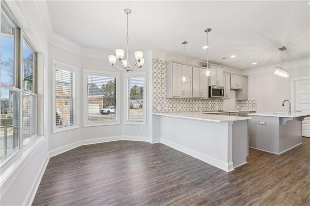 1833 Millstone Manor Conyers, GA 30013 - Photo 19 of 50 a large kitchen with granite countertop a large counter top a sink stainless steel appliances and cabinets