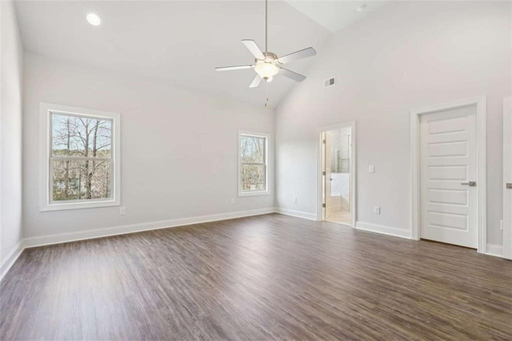 1833 Millstone Manor Conyers, GA 30013 - Photo 22 of 50 wooden floor in an empty room with a window
