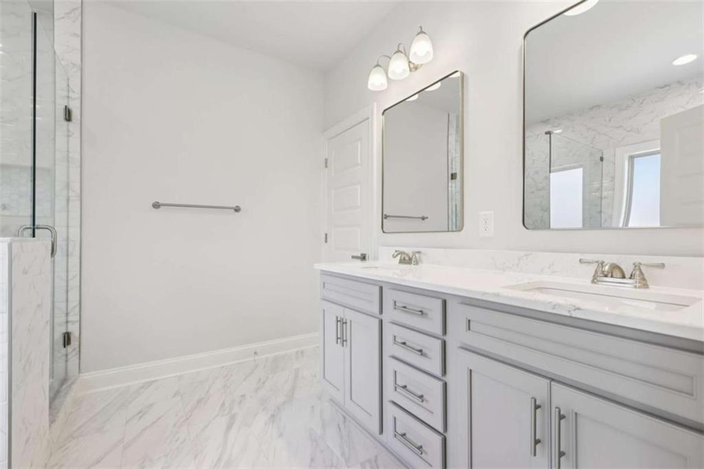 1833 Millstone Manor Conyers, GA 30013 - Photo 24 of 50 a bathroom with a double vanity sink and mirror