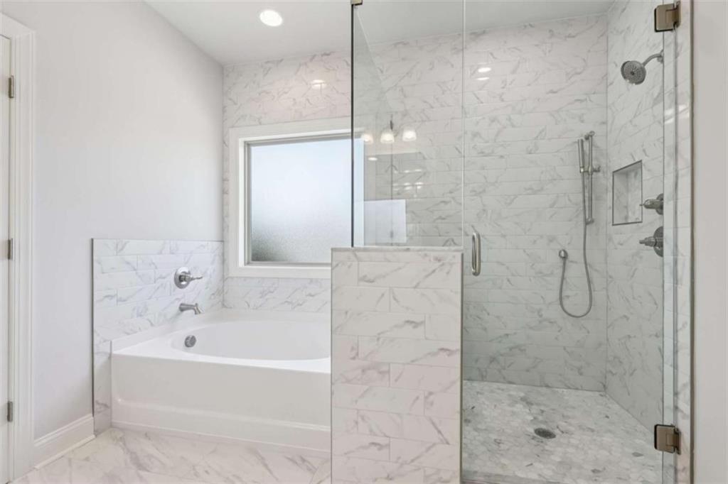 1833 Millstone Manor Conyers, GA 30013 - Photo 25 of 50 a bathroom with a bathtub and shower