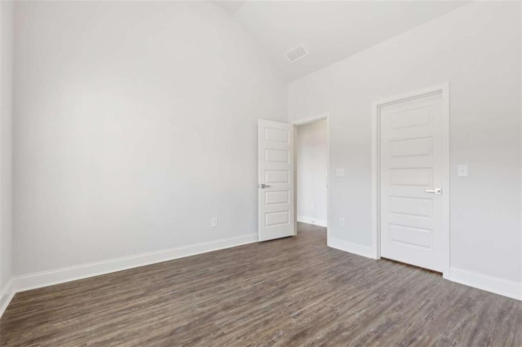 1833 Millstone Manor Conyers, GA 30013 - Photo 28 of 50 an empty room with wooden floor