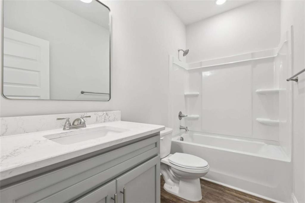 1833 Millstone Manor Conyers, GA 30013 - Photo 29 of 50 a bathroom with a sink a toilet and a bathtub