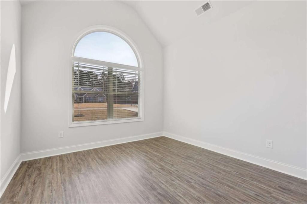 1833 Millstone Manor Conyers, GA 30013 - Photo 30 of 50 an empty room with wooden floor and a window