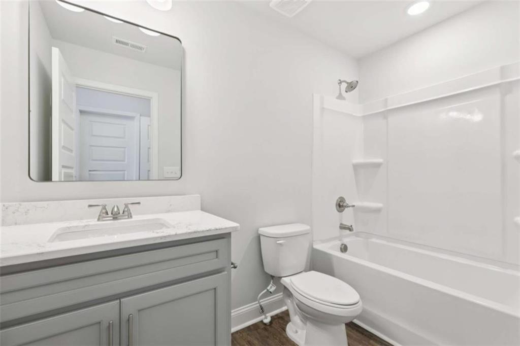 1833 Millstone Manor Conyers, GA 30013 - Photo 34 of 50 a bathroom with a sink toilet vanity and shower
