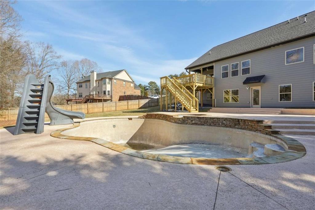 1833 Millstone Manor Conyers, GA 30013 - Photo 45 of 50 a view of swimming pool with a house in the background