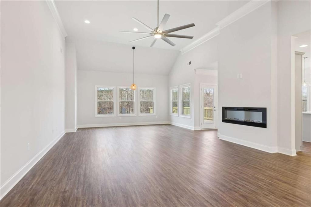 1833 Millstone Manor Conyers, GA 30013 - Photo 6 of 50 a view of an empty room with wooden floor and a window
