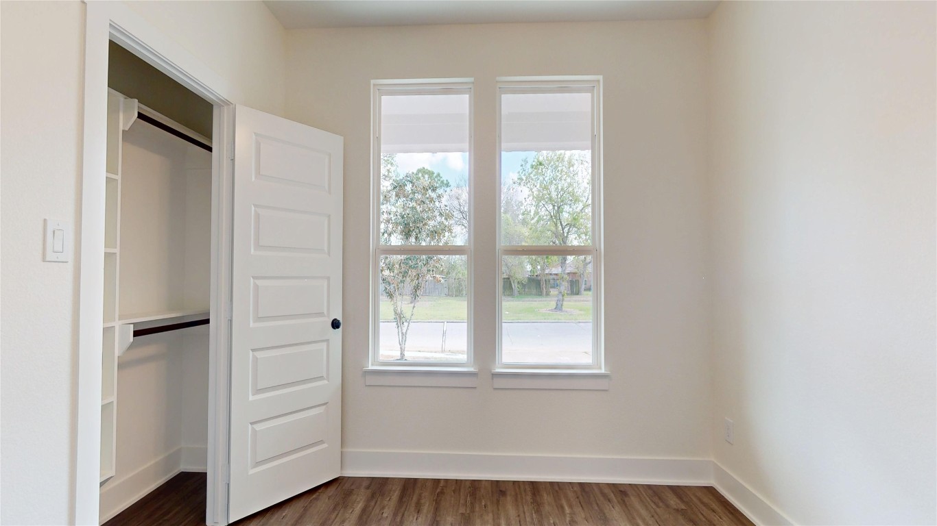 5119 Selinsky Road Houston, TX 77048 - Photo 11 of 45 a view of an empty room with wooden floor and a window
