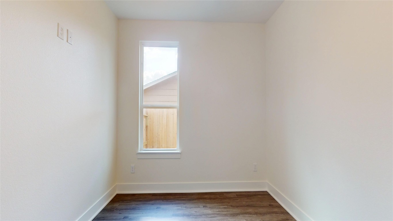 5119 Selinsky Road Houston, TX 77048 - Photo 12 of 45 a view of an empty room with wooden floor and a window