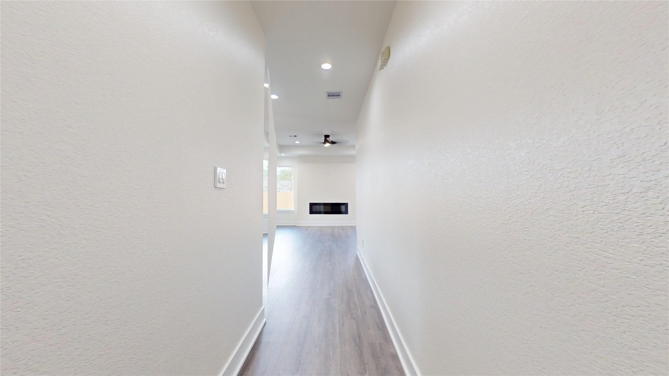 5119 Selinsky Road Houston, TX 77048 - Photo 19 of 45 a view of a hallway with wooden floor