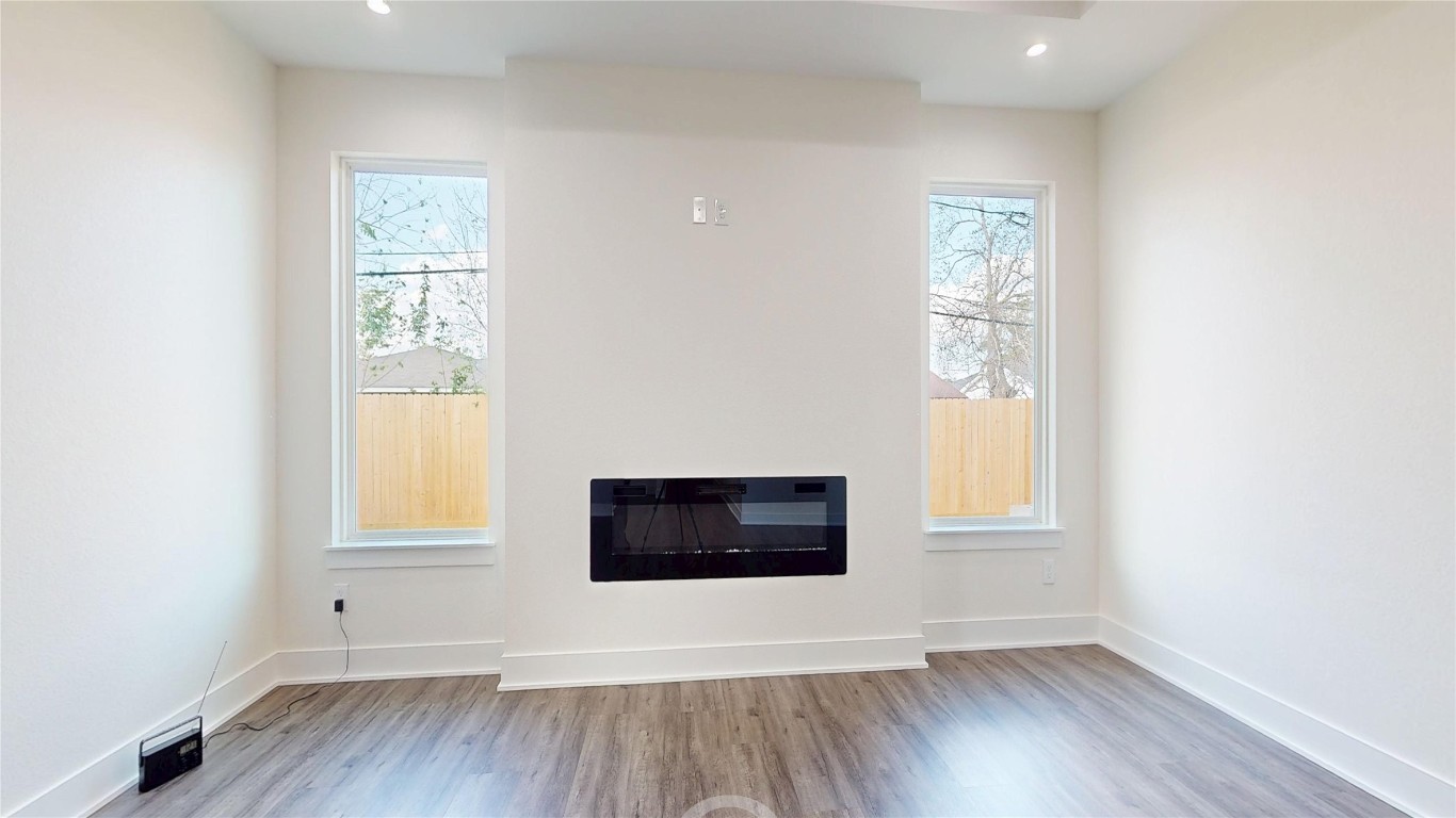 5119 Selinsky Road Houston, TX 77048 - Photo 27 of 45 an empty room with wooden floor and windows