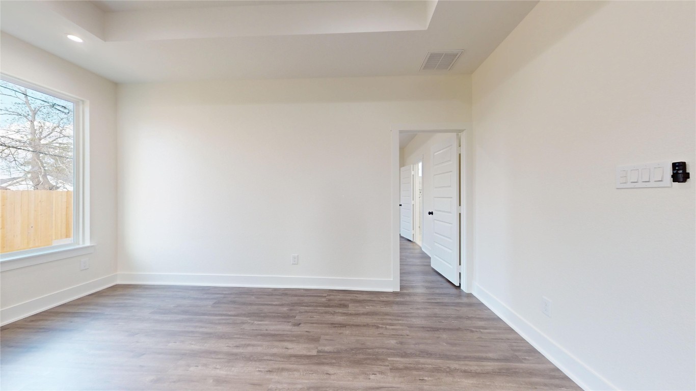 5119 Selinsky Road Houston, TX 77048 - Photo 29 of 45 a view of an empty room with wooden floor and a window