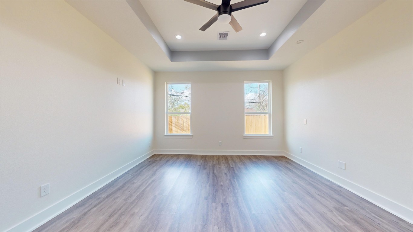 5119 Selinsky Road Houston, TX 77048 - Photo 31 of 45 wooden floor in an empty room with a window