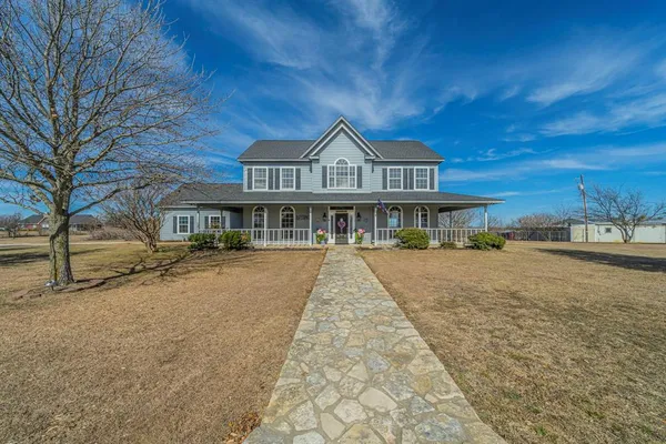 a view of house with yard