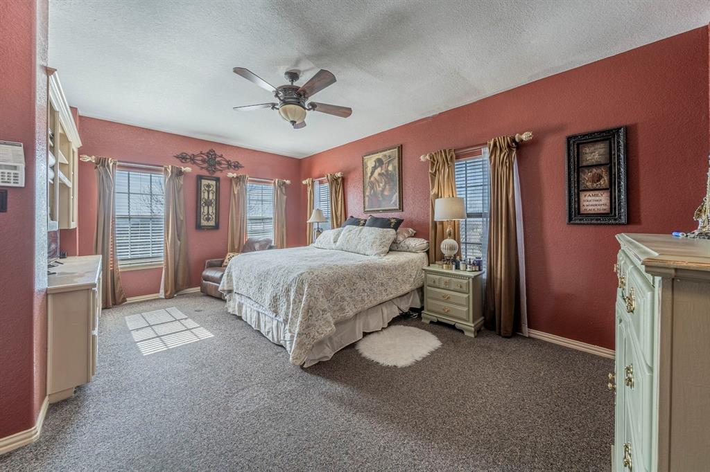 6438 Farm To Market 4 Godley, TX 76044 - Photo 12 of 32 a bedroom with a bed chandelier and a window
