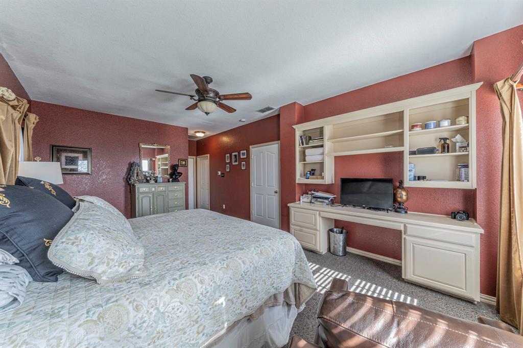 6438 Farm To Market 4 Godley, TX 76044 - Photo 13 of 32 a bed room with a bed and a television