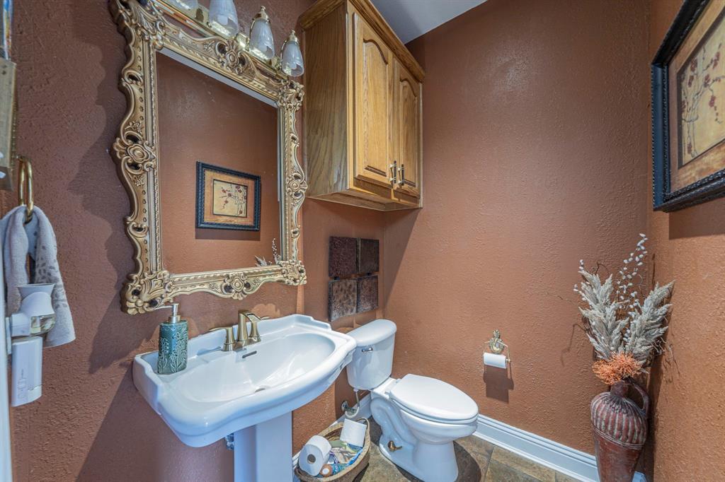 6438 Farm To Market 4 Godley, TX 76044 - Photo 18 of 32 a bathroom with a toilet sink and mirror