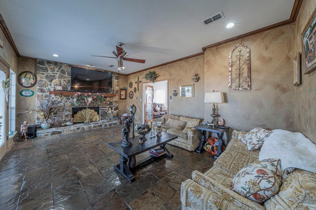 6438 Farm To Market 4 Godley, TX 76044 - Photo 4 of 32 a living room with furniture and a chandelier