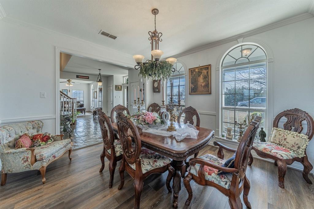 6438 Farm To Market 4 Godley, TX 76044 - Photo 6 of 32 a view of a dining room with furniture window and wooden floor