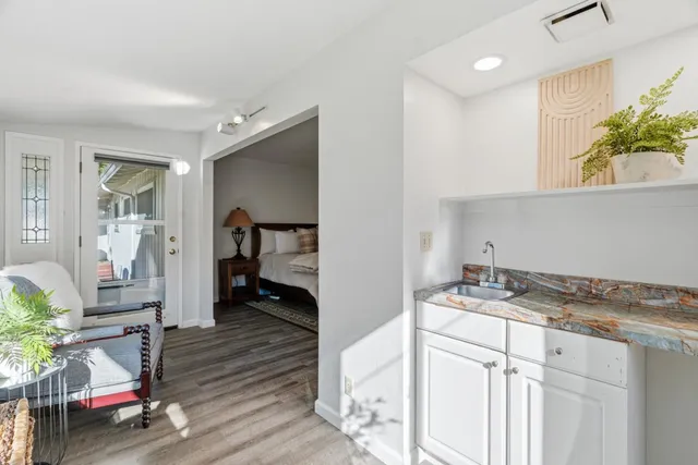 a bedroom with a bed and a painting on the wall