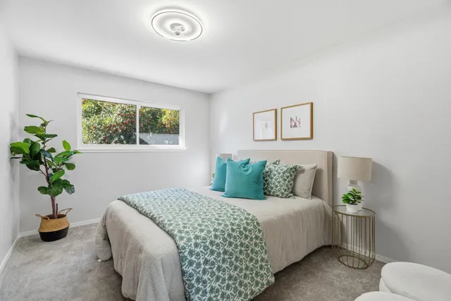 a work room with furniture and a potted plant