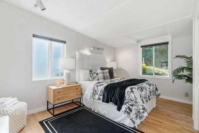 a front view of a house with a garden and sitting area
