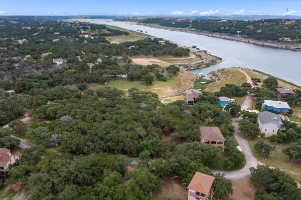 an aerial view of lake residential house and ocean view