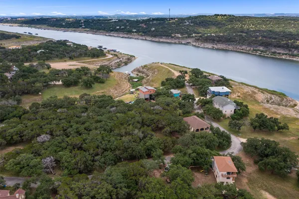 an aerial view of ocean with residential house and lake