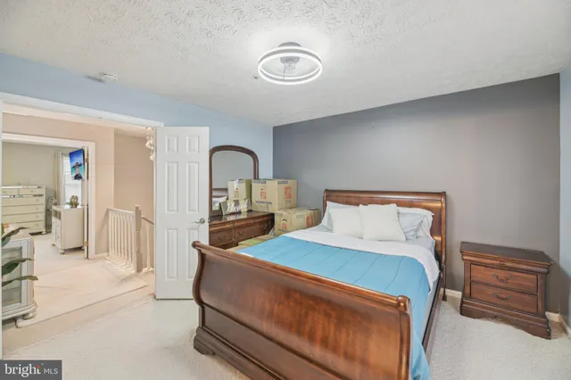 a bedroom with a bed and a dresser with mirror