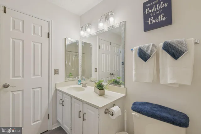 a bathroom with a sink a mirror and a shower