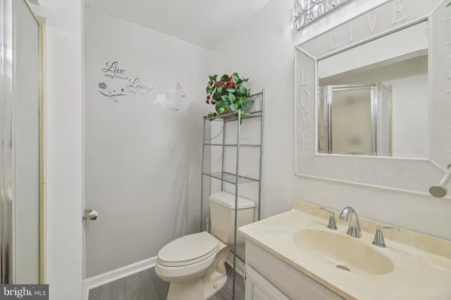 a bathroom with a sink toilet and mirror