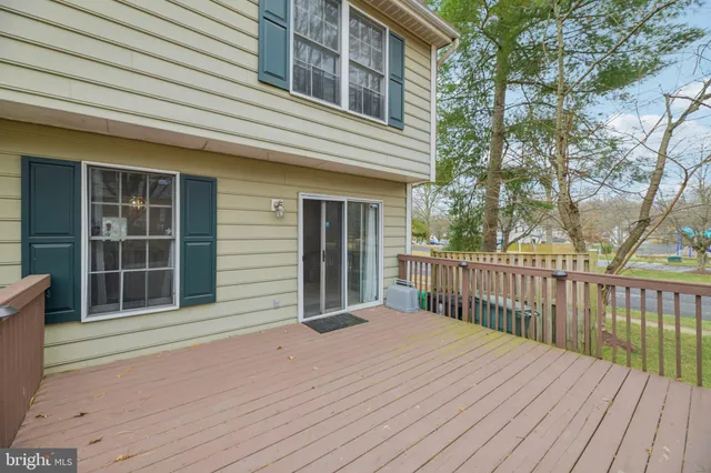 a view of backyard with deck and wooden floor
