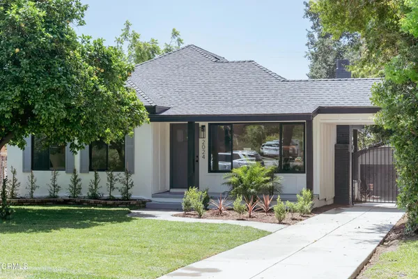 a front view of house with yard and outdoor seating