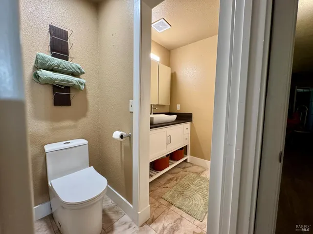 a bathroom with a toilet sink and mirror