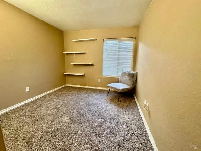 a bathroom with a granite countertop sink and a toilet
