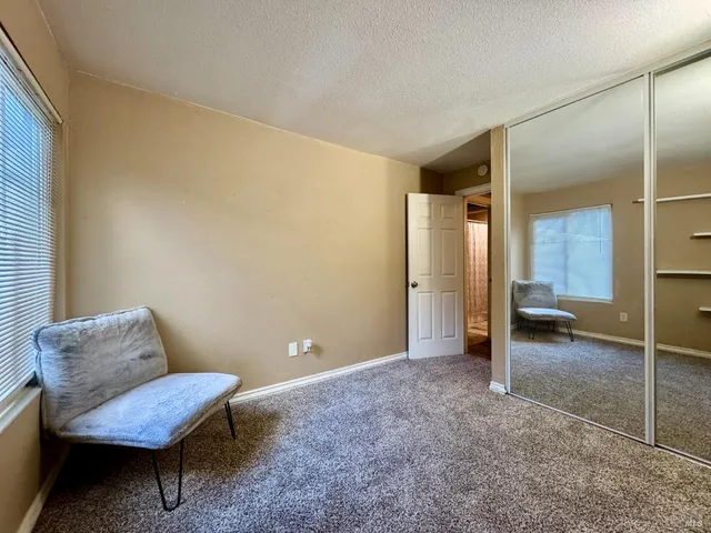 a view of a livingroom with furniture and a bathroom