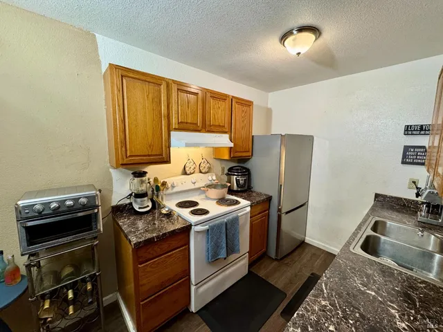 a kitchen with a stove and a refrigerator