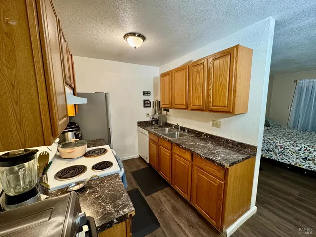 a kitchen with a sink stove and refrigerator