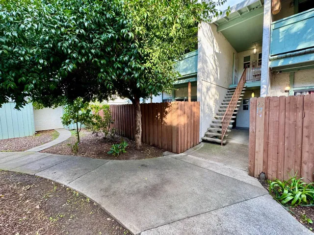 a view of a house with a backyard