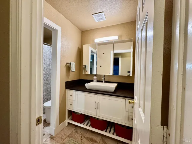 a en suite bathroom with a sink and a mirror