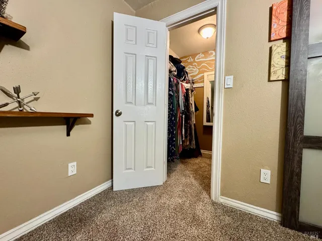 a view of a hallway with closet